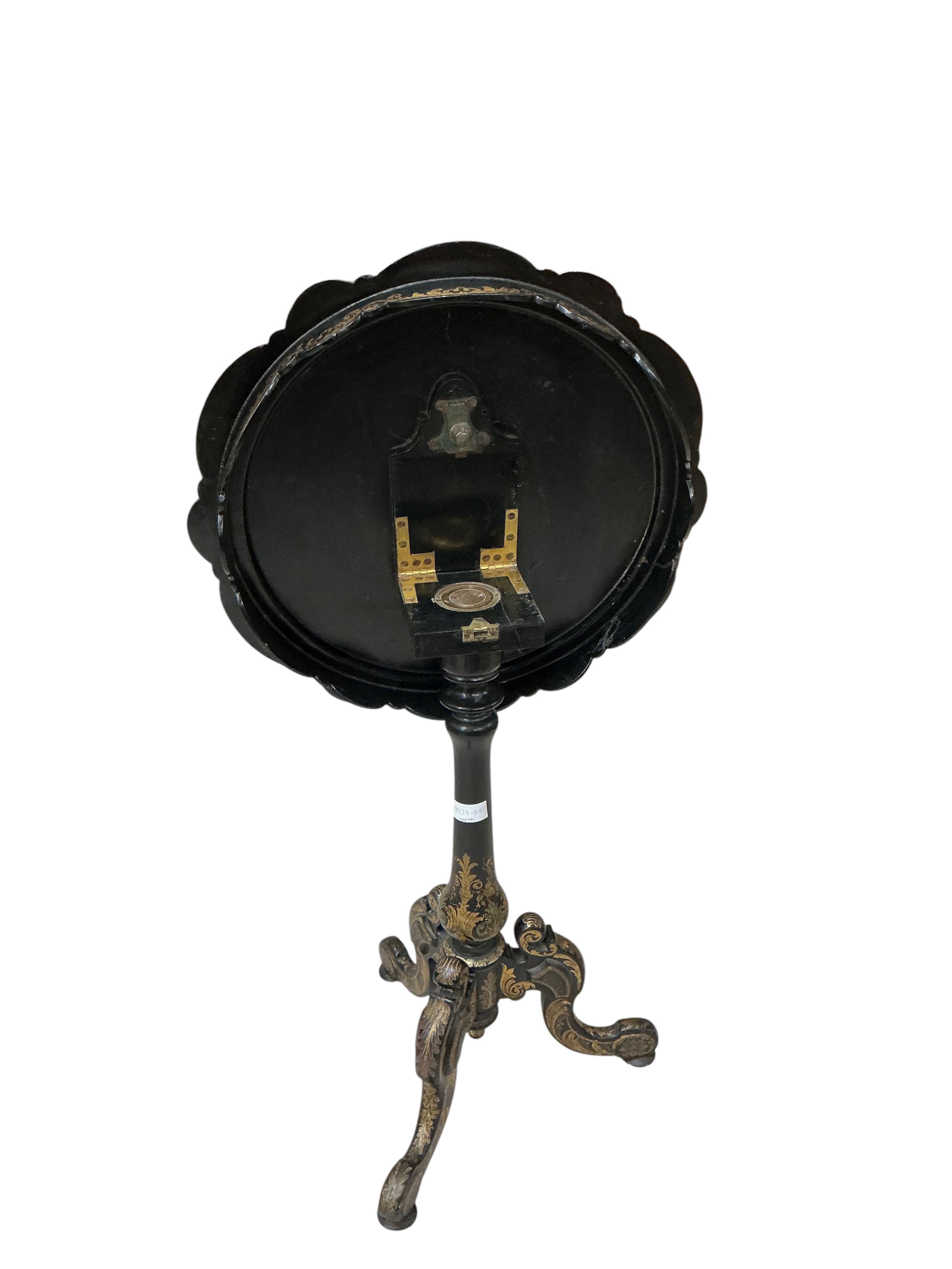 A Victorian mother of pearl inlaid papier mache circular tilt top tripod games table, diameter 56cm, height 74cm